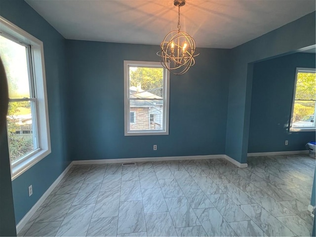 empty room with an inviting chandelier