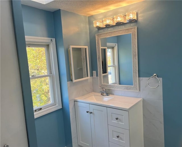 bathroom with a textured ceiling and vanity