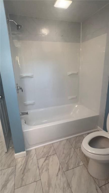 bathroom with bathtub / shower combination and toilet