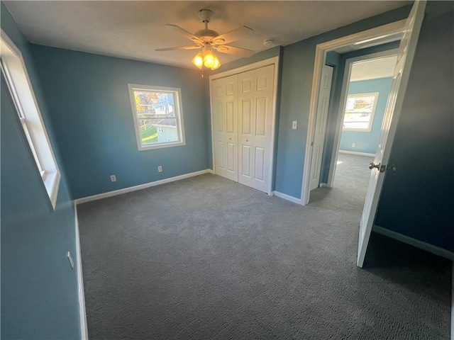 unfurnished bedroom with carpet, ceiling fan, and a closet