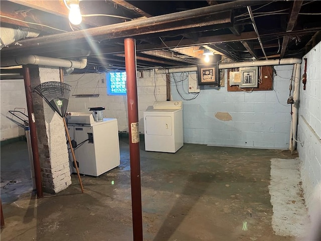 basement featuring electric panel and white refrigerator