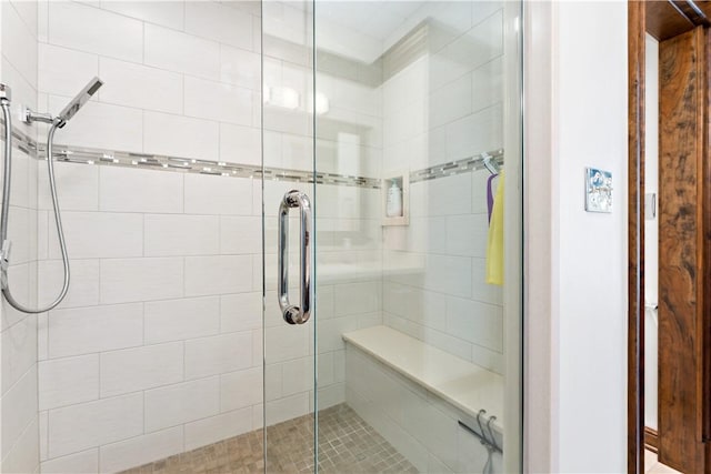 bathroom featuring a shower with door