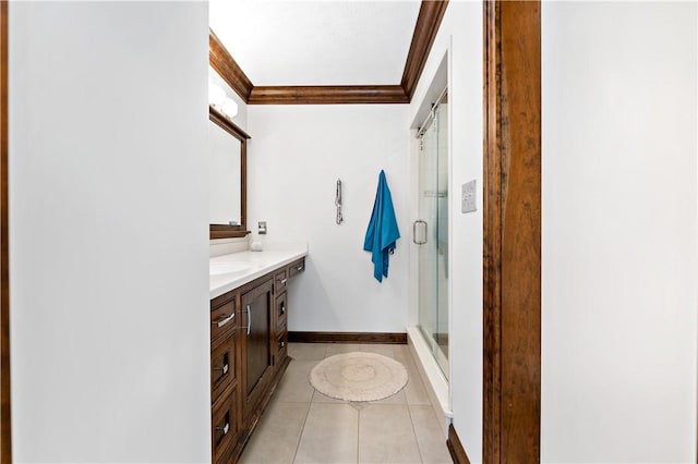 bathroom featuring tile patterned flooring, vanity, an enclosed shower, and ornamental molding