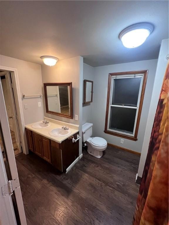 bathroom with hardwood / wood-style floors, vanity, and toilet