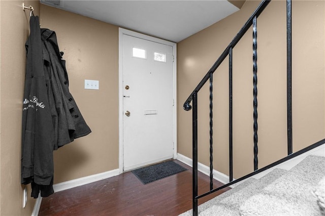 entryway with dark hardwood / wood-style flooring