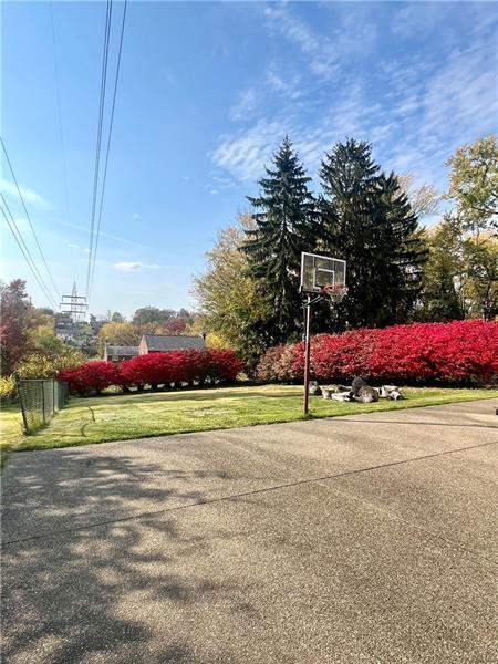 view of sport court with a yard