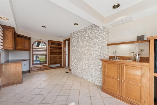 kitchen with sink and light tile patterned flooring