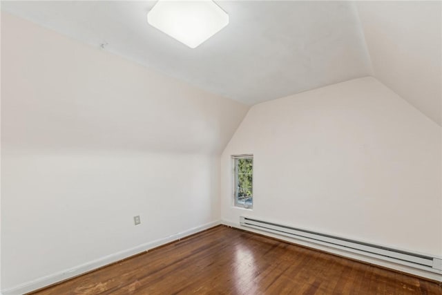 bonus room featuring lofted ceiling, dark wood-type flooring, and a baseboard heating unit