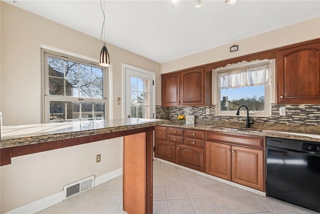 kitchen with pendant lighting, dishwasher, a healthy amount of sunlight, and sink