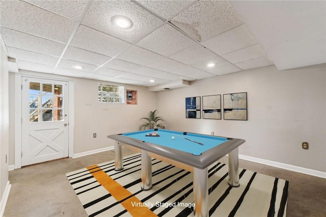 rec room with a paneled ceiling, concrete floors, and billiards