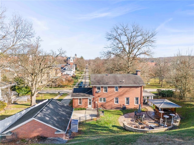 back of property featuring a lawn