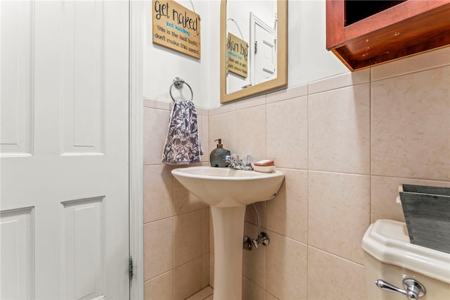 bathroom with tile walls