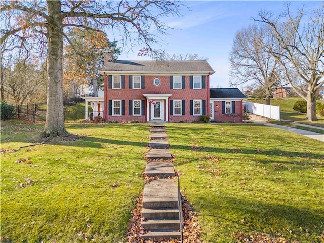 colonial home with a front lawn