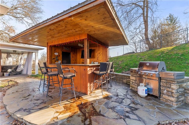 view of patio / terrace with area for grilling and exterior bar