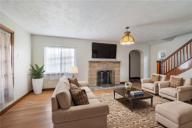 living room featuring a fireplace and light hardwood / wood-style floors