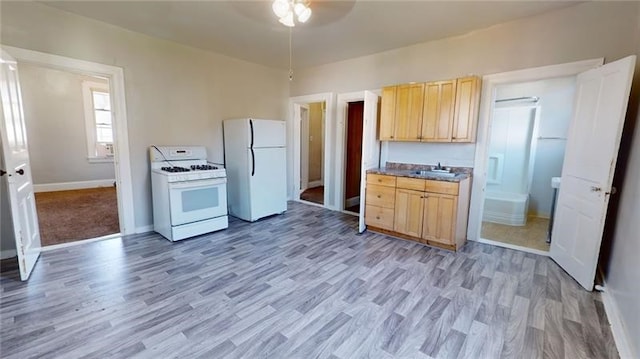 kitchen with light brown cabinetry, white appliances, ceiling fan, sink, and light hardwood / wood-style floors