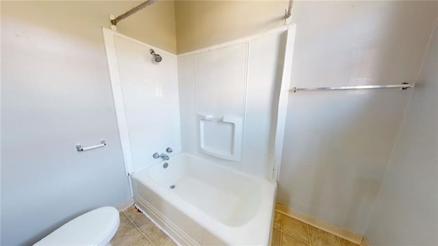 bathroom with tile patterned floors, shower / bath combination, and toilet