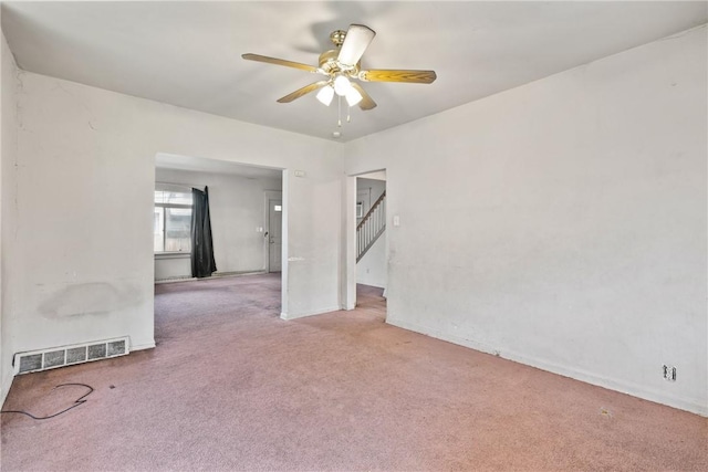 carpeted spare room with ceiling fan