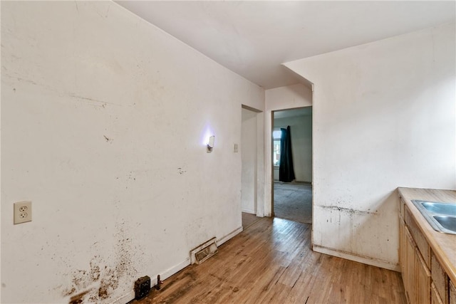 interior space with sink and light hardwood / wood-style flooring