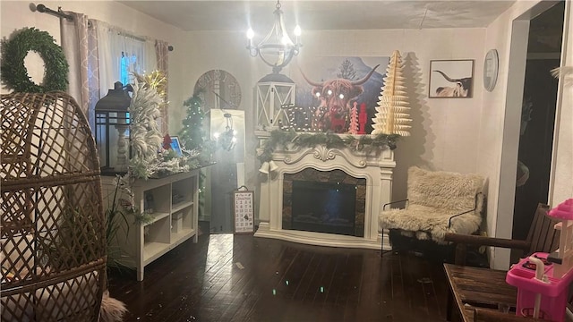 living area featuring a notable chandelier and hardwood / wood-style flooring