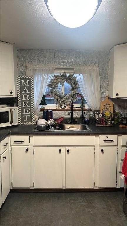 kitchen with white cabinetry and sink