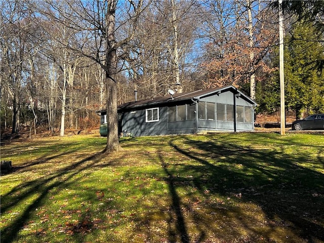 exterior space featuring a sunroom and a yard