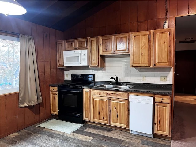 kitchen with lofted ceiling, wood walls, dark hardwood / wood-style flooring, and white appliances