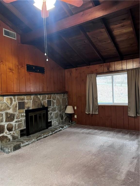 unfurnished living room with carpet, vaulted ceiling with beams, and wooden walls