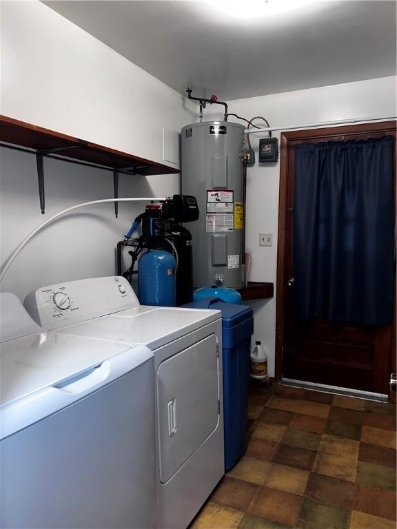 clothes washing area with electric water heater and washing machine and dryer