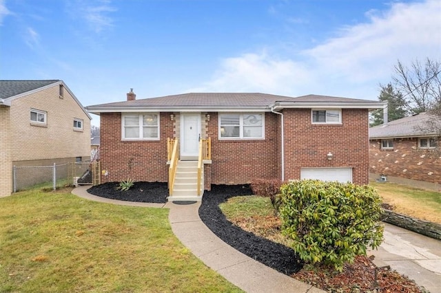 view of front of home with a front lawn and a garage