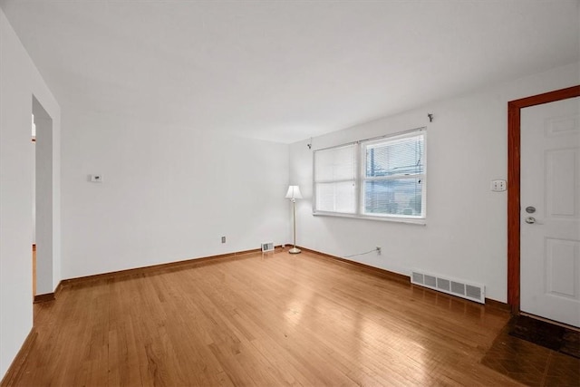 empty room with hardwood / wood-style floors