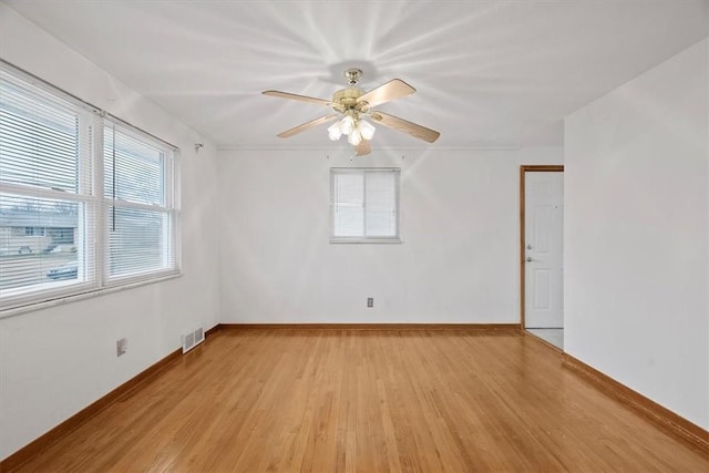 empty room featuring ceiling fan and light hardwood / wood-style floors