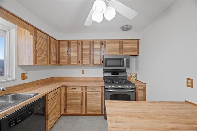 kitchen with wooden counters, black dishwasher, ceiling fan, and sink