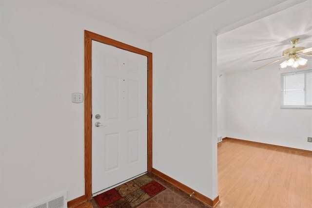 entryway with ceiling fan and wood-type flooring