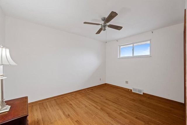 empty room featuring hardwood / wood-style floors and ceiling fan