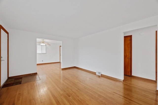 spare room with ceiling fan and wood-type flooring