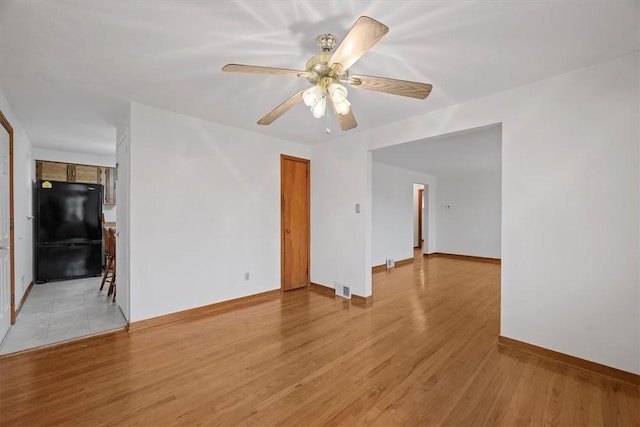 unfurnished room featuring ceiling fan and light hardwood / wood-style flooring