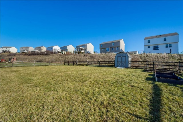 view of yard with a rural view and a storage shed