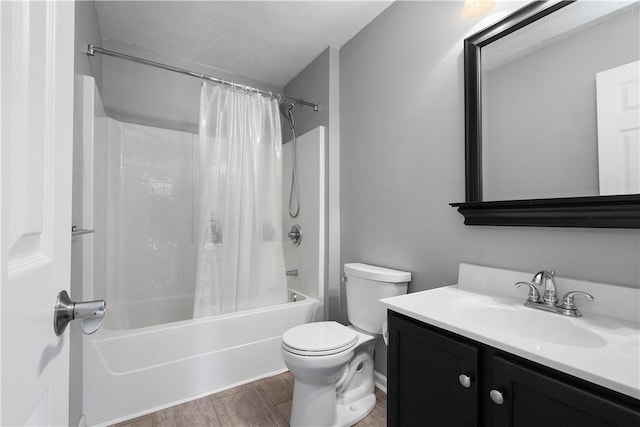 full bathroom featuring vanity, shower / bath combination with curtain, hardwood / wood-style flooring, toilet, and a textured ceiling