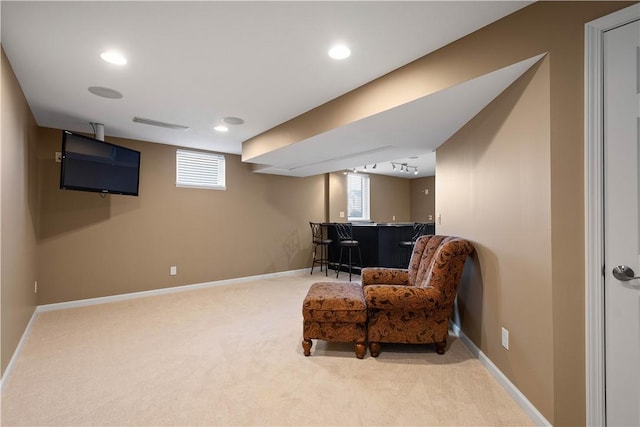 sitting room featuring carpet flooring and indoor bar