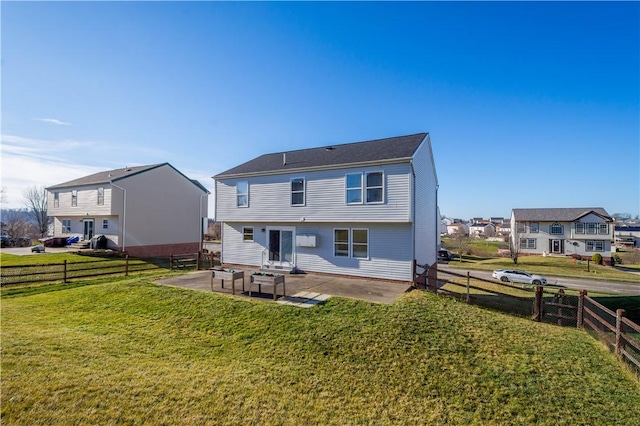 rear view of house with a patio area and a lawn