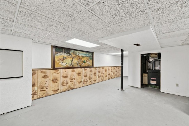 basement featuring a paneled ceiling