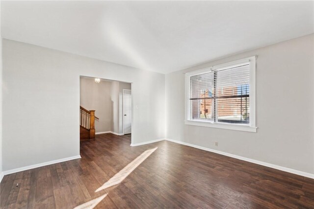 unfurnished room featuring dark wood-type flooring