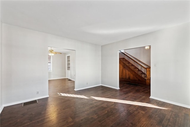 spare room with ceiling fan and dark hardwood / wood-style flooring