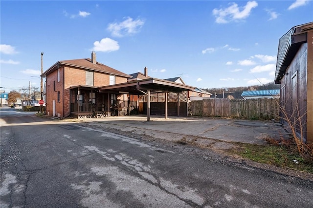 rear view of house featuring a carport