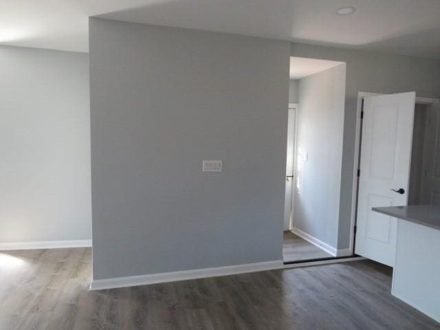 empty room with wood finished floors and baseboards