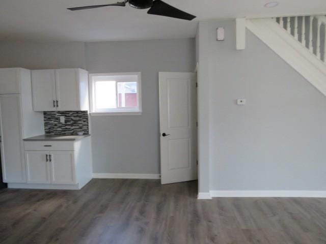 kitchen with decorative backsplash, white cabinets, wood finished floors, and ceiling fan