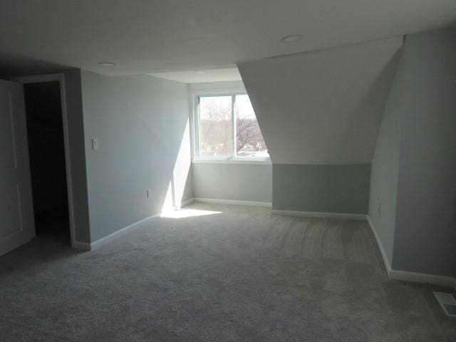 bonus room with carpet flooring, visible vents, and baseboards