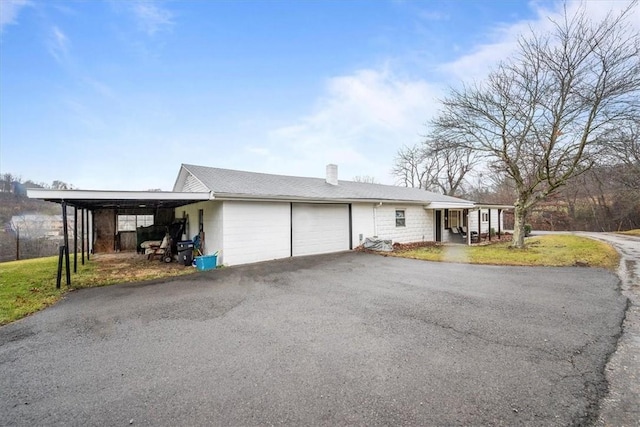 ranch-style house with a garage and a carport