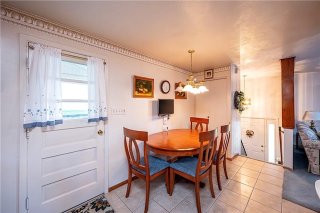 dining area featuring light tile patterned floors and a chandelier